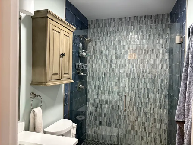 a bathroom with a shower and a sink