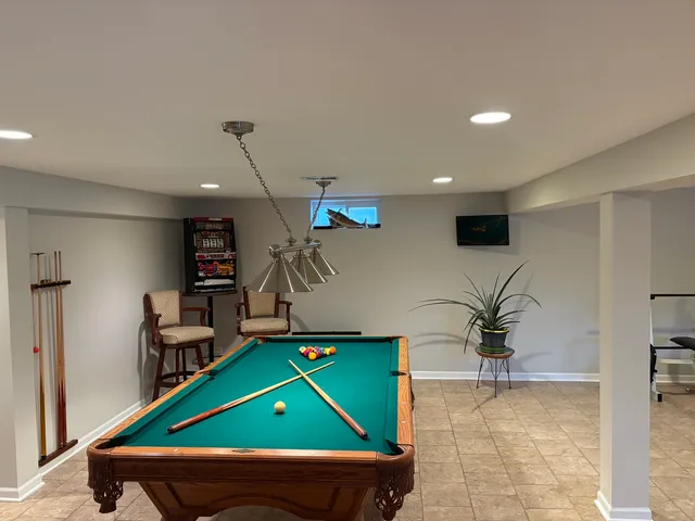 wooden room with furniture and a ceiling fan