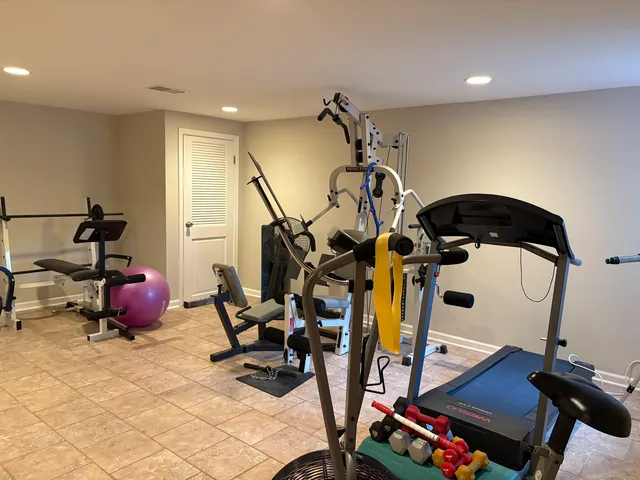 a room with gym equipment and mirror