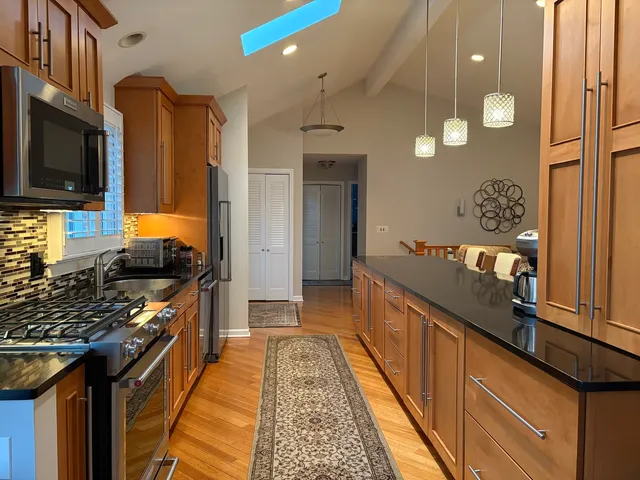 a kitchen with stainless steel appliances granite countertop a stove and a sink
