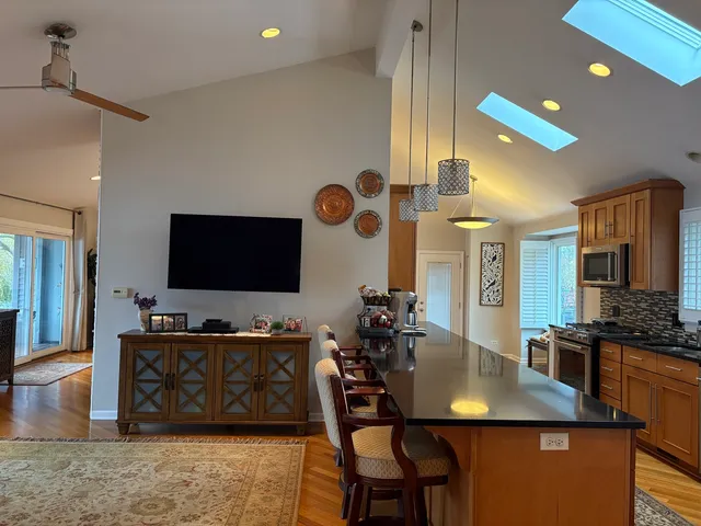 a large kitchen with a table and chairs in it