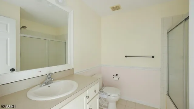 a bathroom with a sink toilet and a mirror