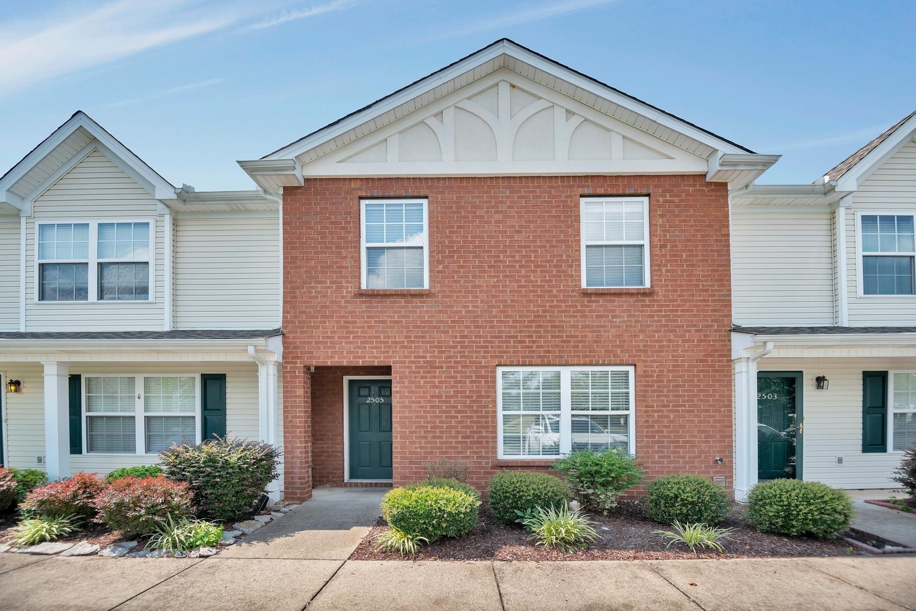 front view of brick house with a yard