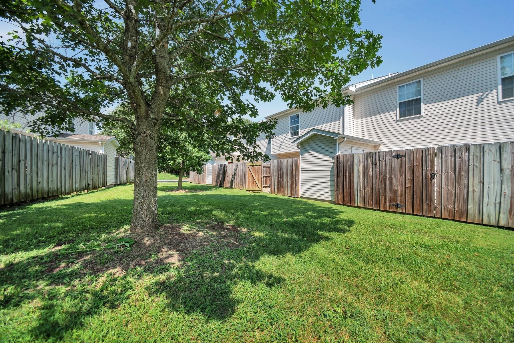 2505 Comanche Way Murfreesboro, TN 37128 - Photo 20 of 21 a view of a backyard with large trees and wooden fence