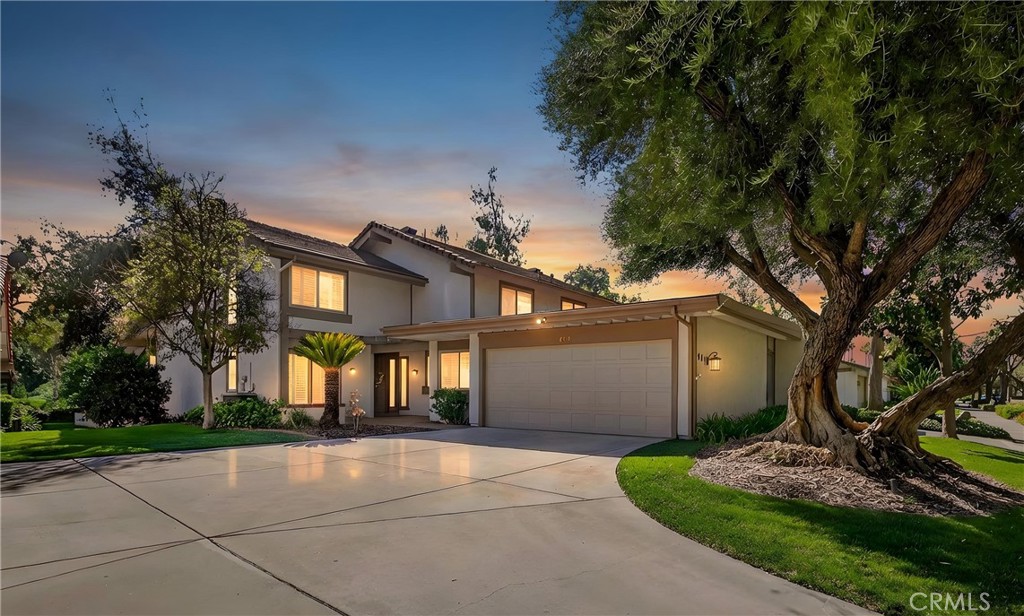 a view of a house with a yard and tree s