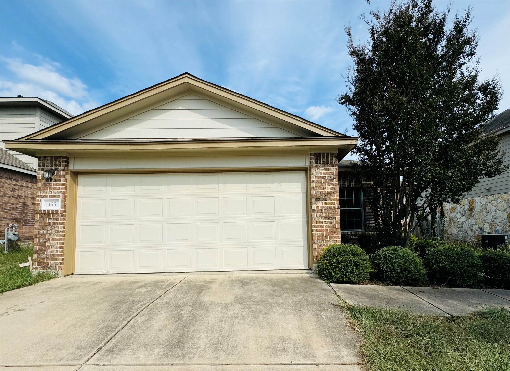 155 Dragon Ridge Road Buda, TX 78610 - Photo 1 of 1 a front view of a house with a yard and garage