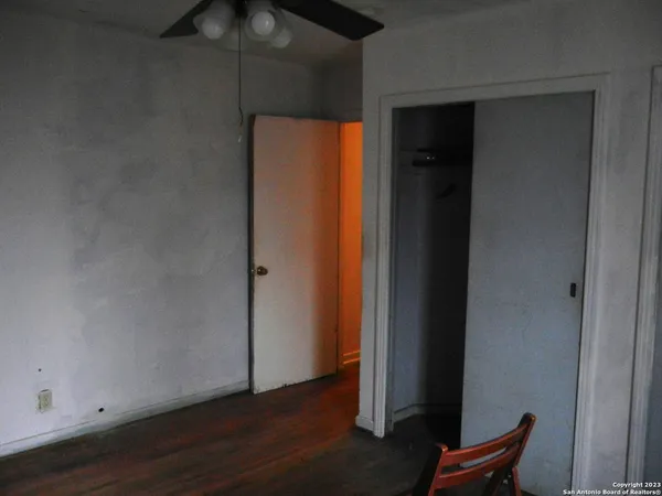 an empty room with wooden floor and closet