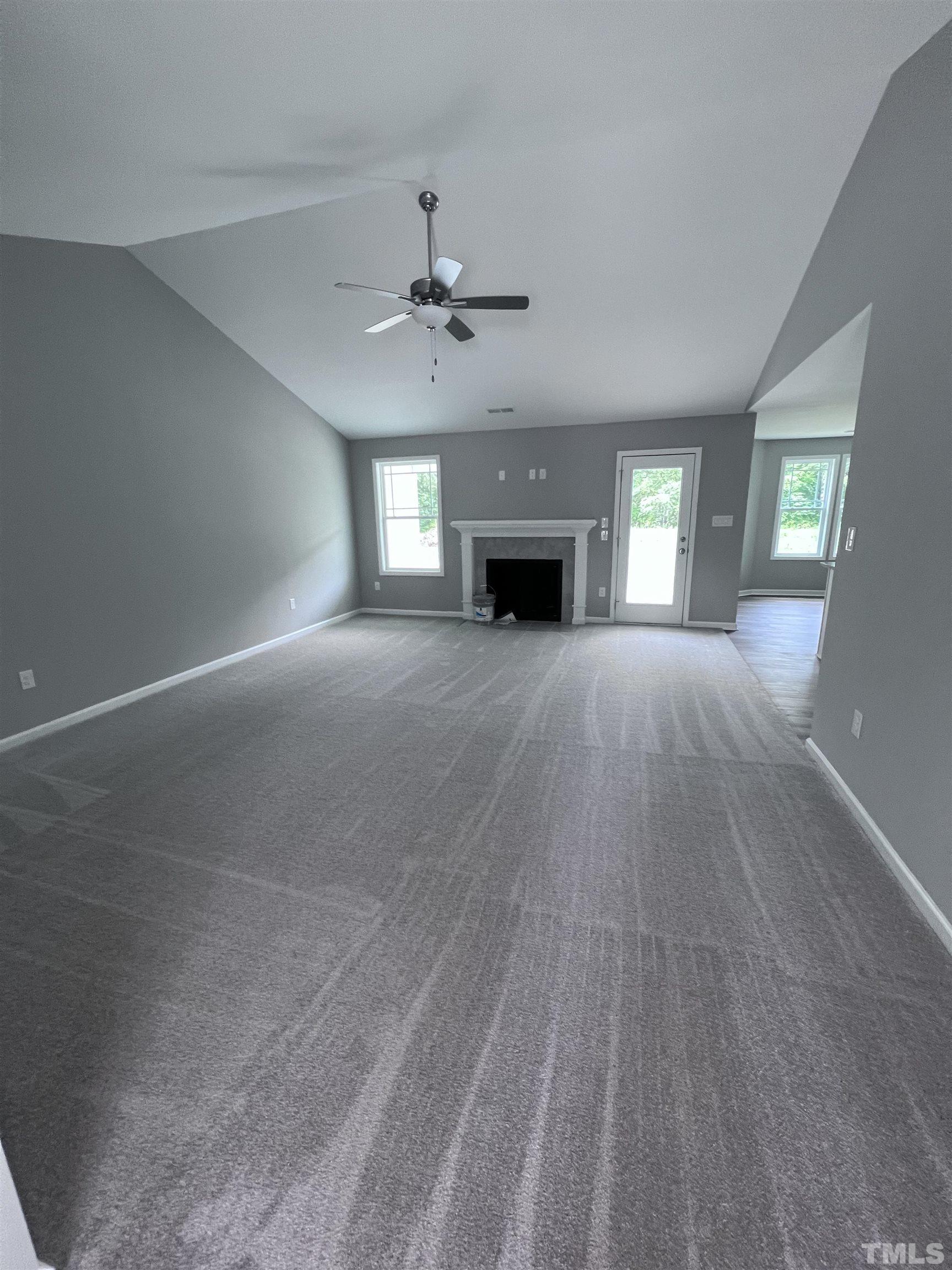 1294 Lee Road Clayton, NC 27520 - Photo 3 of 15 a view of empty room with fireplace and wooden floor