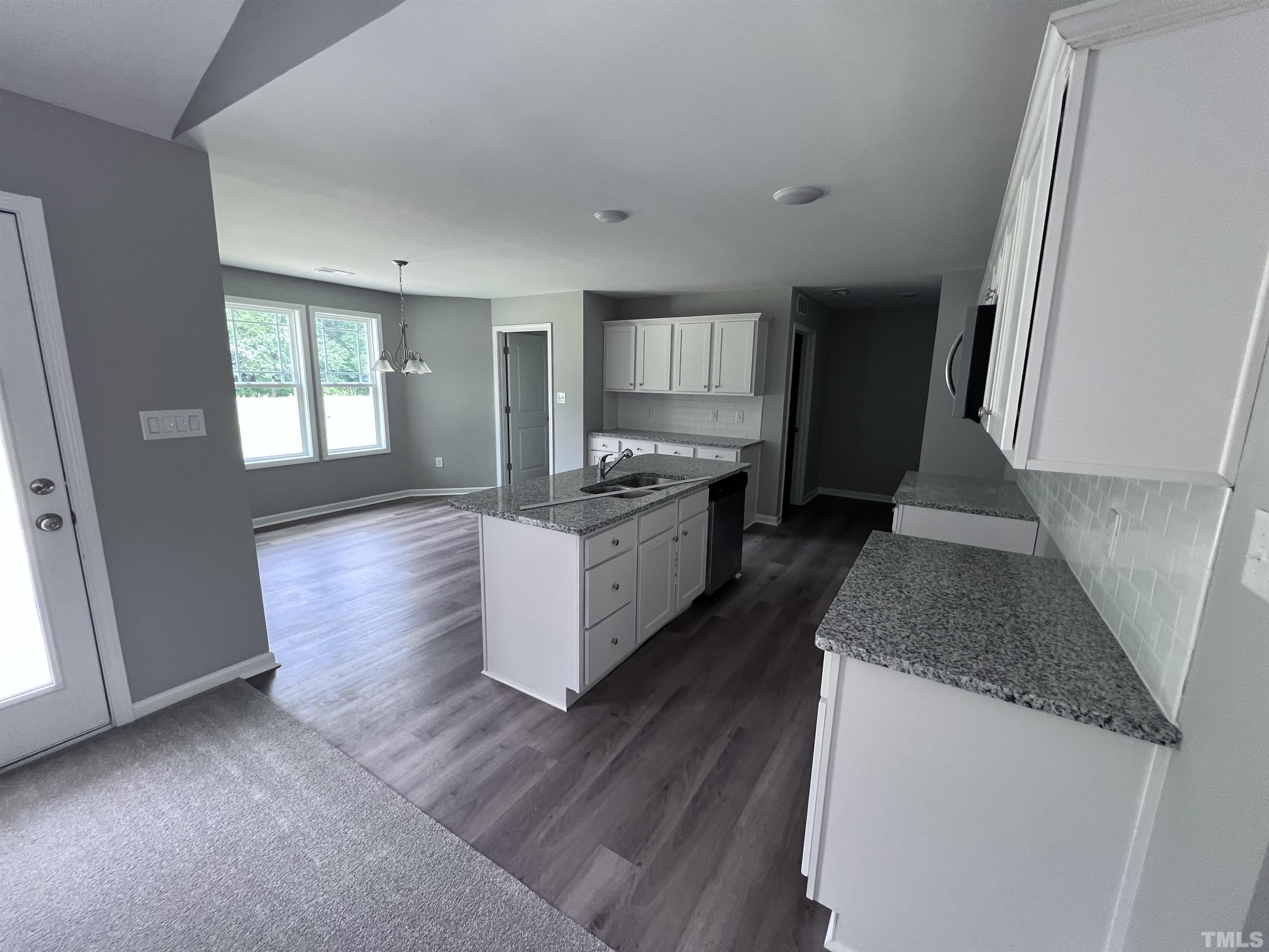 1294 Lee Road Clayton, NC 27520 - Photo 5 of 15 a kitchen with granite countertop wooden floors and wide window