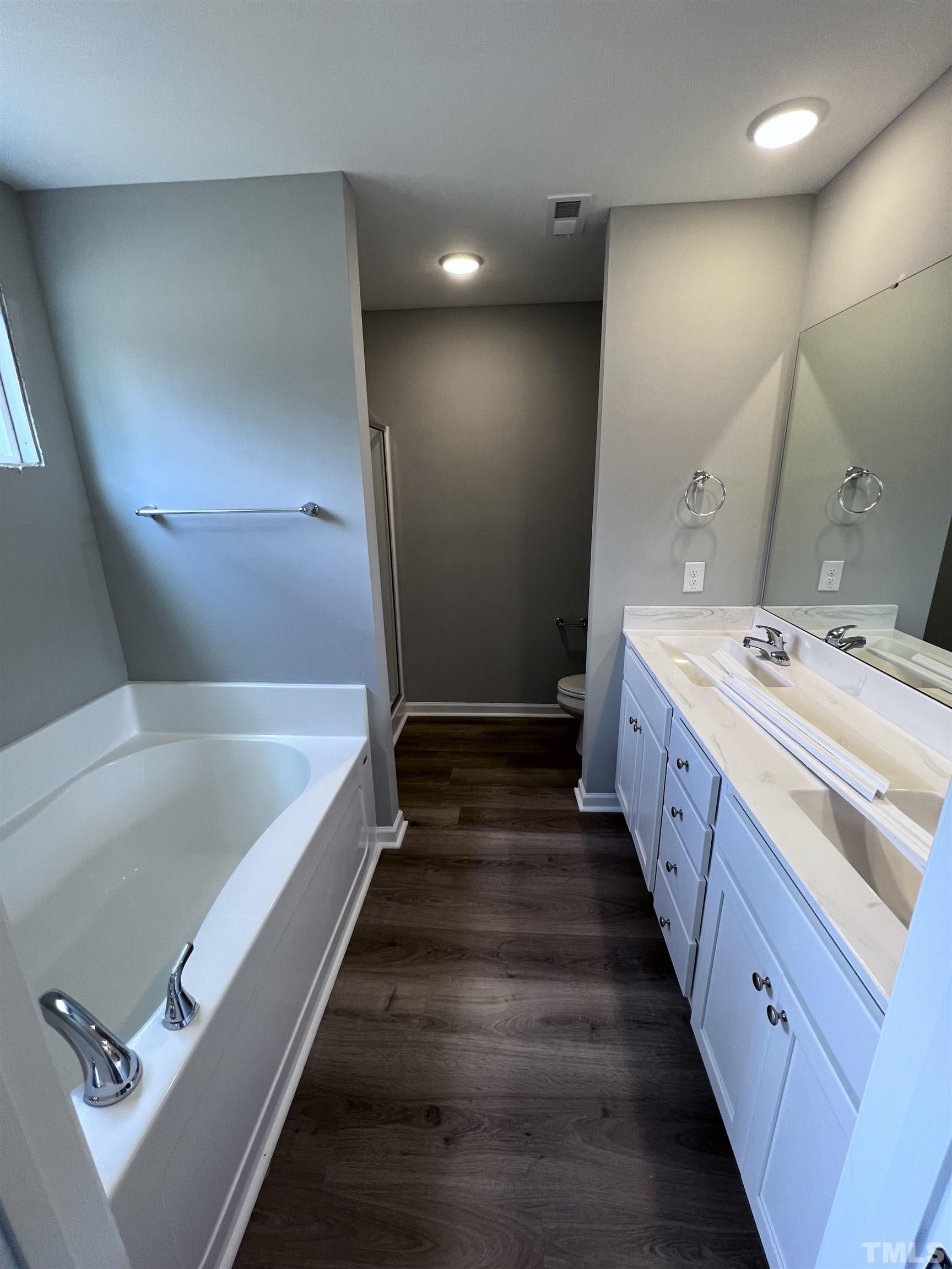1294 Lee Road Clayton, NC 27520 - Photo 8 of 15 a bathroom with a tub sink and mirror