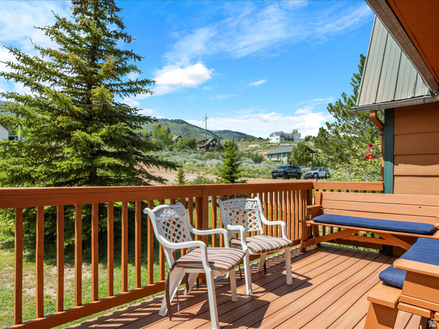 371 Lewis Loop, Unit 29 Fish Haven, ID 83287 - Photo 15 of 40 Expansive wood-finish deck with wooden railing and built-in bench seating