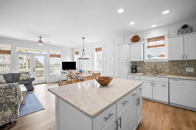 a kitchen with sink stove and cabinets