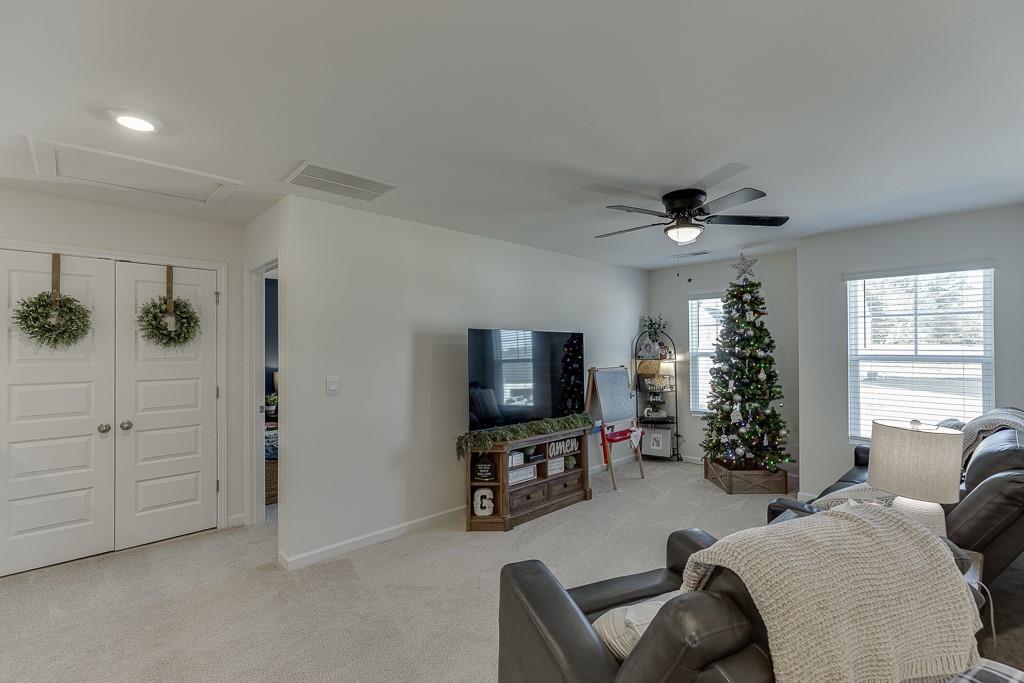 236 Ralph Still Road Dacula, GA 30019 - Photo 19 of 68 a living room with furniture and a flat screen tv