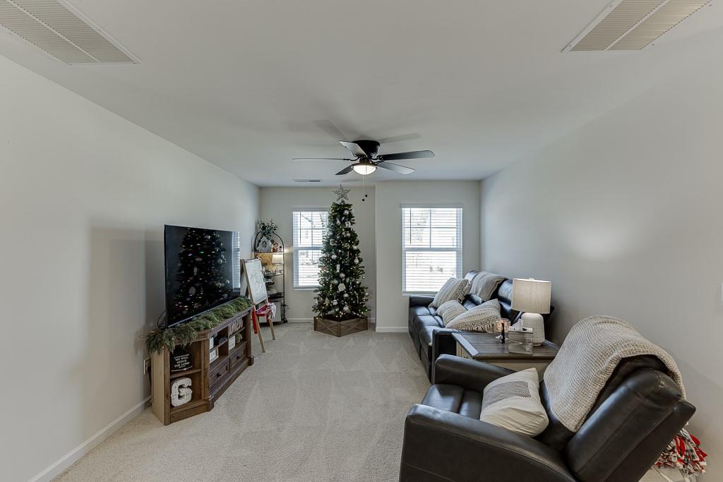 236 Ralph Still Road Dacula, GA 30019 - Photo 20 of 68 a living room with furniture a window and a flat screen tv