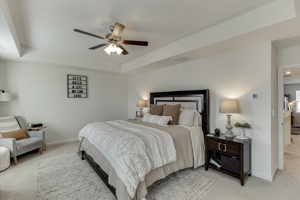 236 Ralph Still Road Dacula, GA 30019 - Photo 31 of 68 a bedroom with a bed and ceiling fan