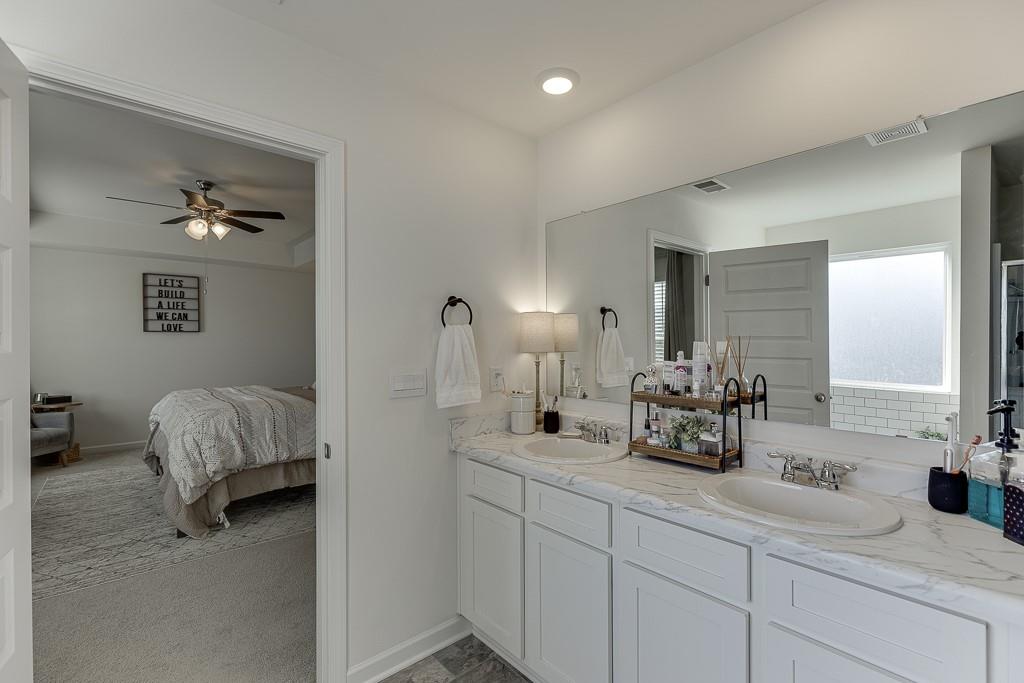236 Ralph Still Road Dacula, GA 30019 - Photo 34 of 68 a en suite bathroom with 2 sink flowerpot and a mirror