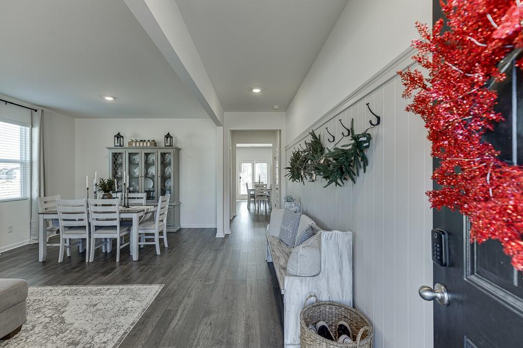 236 Ralph Still Road Dacula, GA 30019 - Photo 4 of 68 a living room with furniture a dining table wooden floor and a large window