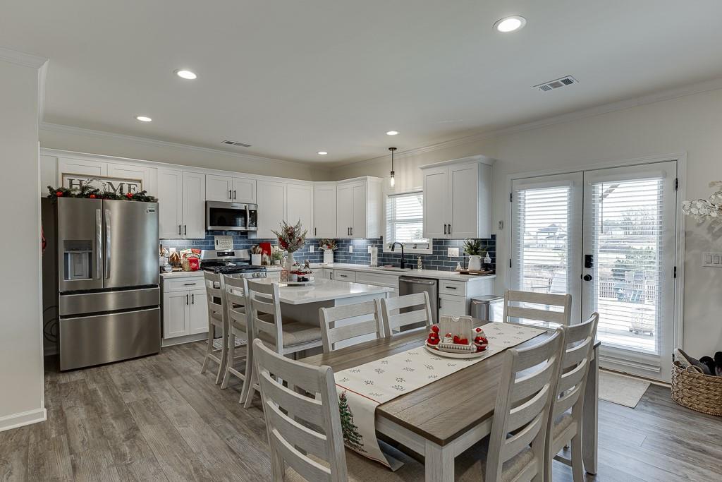 236 Ralph Still Road Dacula, GA 30019 - Photo 43 of 68 a kitchen with refrigerator and wooden floor