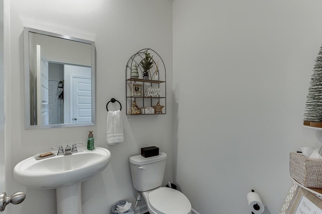 236 Ralph Still Road Dacula, GA 30019 - Photo 8 of 68 a bathroom with a toilet sink and mirror