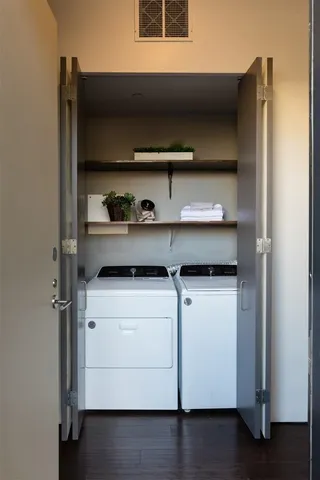 a living room with furniture and painting on the wall