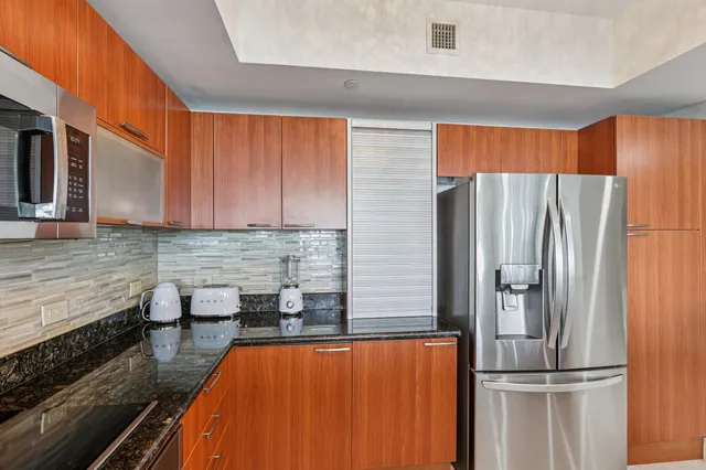 a kitchen with stainless steel appliances granite countertop a sink and cabinets