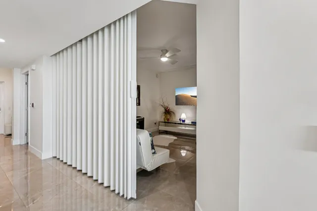 a bedroom with a bed and painting on the wall