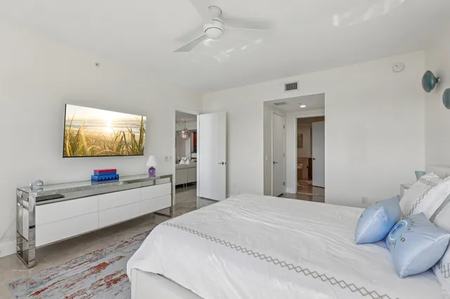a bathroom with a double vanity sink a mirror and bathtub