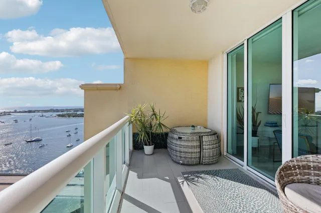 a roof deck with table and chairs a barbeque