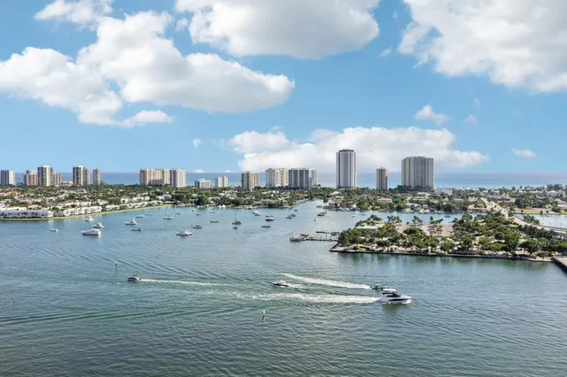 a view of a garden with lawn chairs under an umbrella