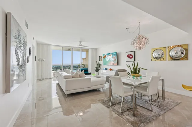 a living room with furniture and kitchen view