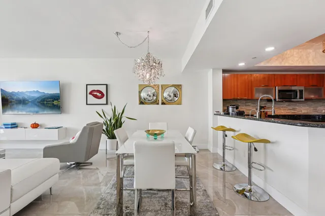 a living room with furniture potted plant and a chandelier