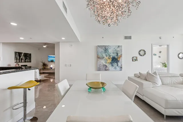 a kitchen with stainless steel appliances granite countertop a sink and a refrigerator