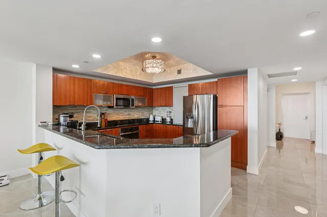 a kitchen with stainless steel appliances granite countertop a stove and a sink