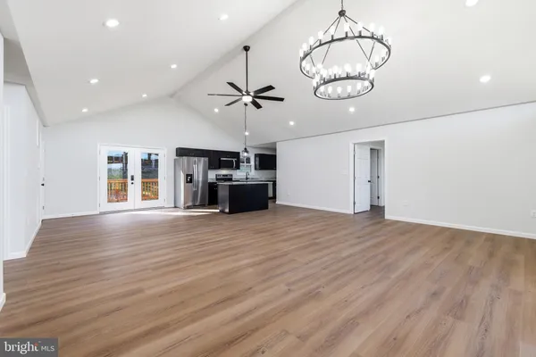 a view of a big room with wooden floor closet and windows