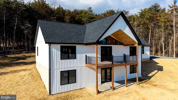 a kitchen with kitchen island white cabinets and stainless steel appliances