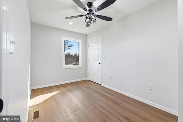 a front view of a house with a yard covered with snow in front of house