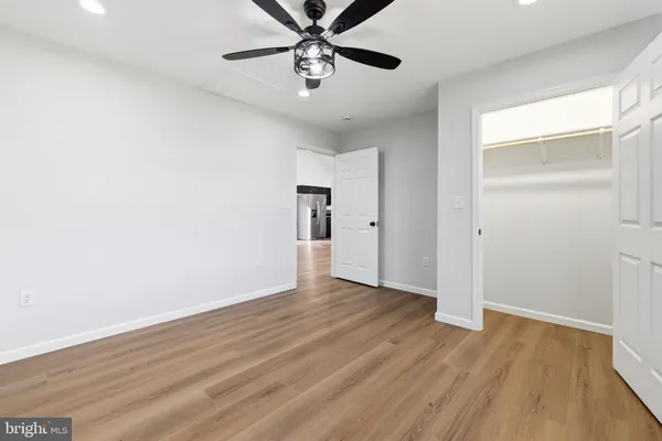 a front view of a house with a garden and parking space