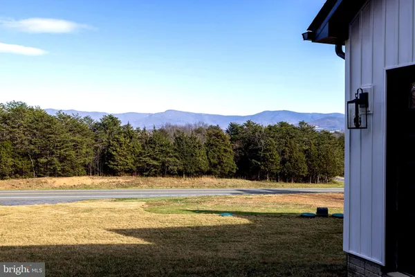 a kitchen with granite countertop stainless steel appliances a sink stove top oven and wooden floor