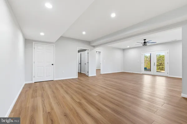 a view of a backyard with snow on the road
