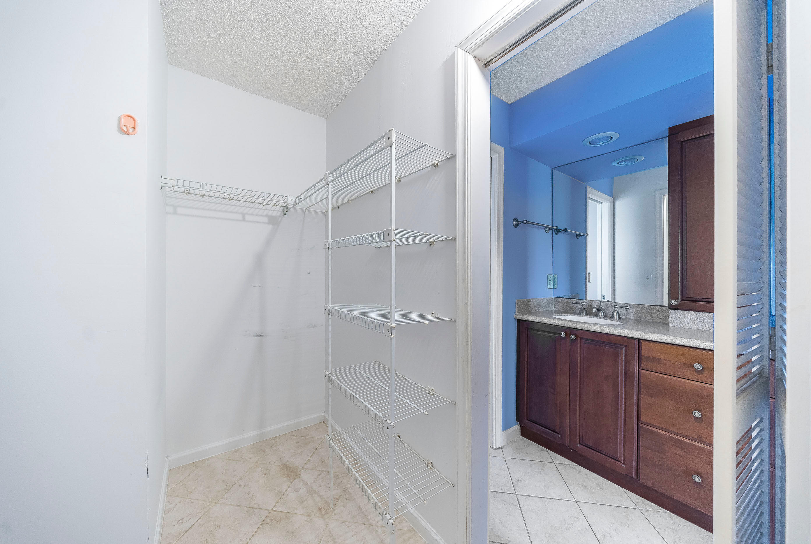 7723 Solimar Circle Boca Raton, FL 33433 - Photo 23 of 40 a bathroom with a granite countertop sink and a mirror