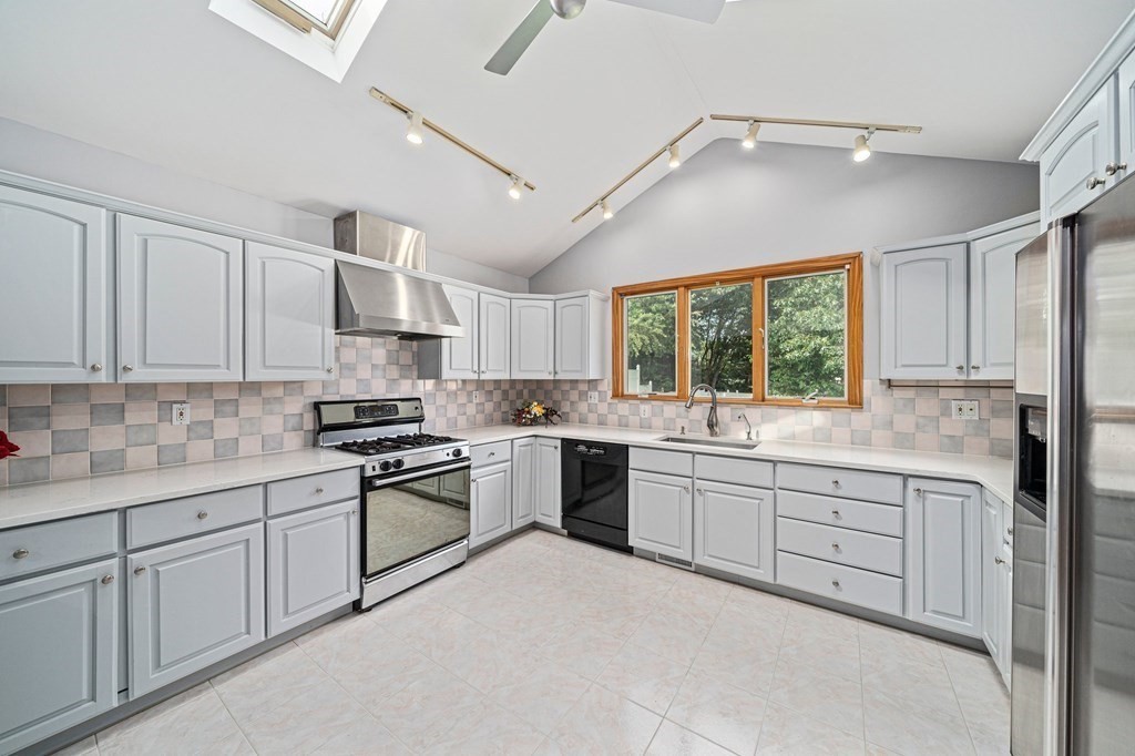 19 Ledge Hill Street Randolph, MA 02368 - Photo 11 of 37 a kitchen with sink cabinets and window