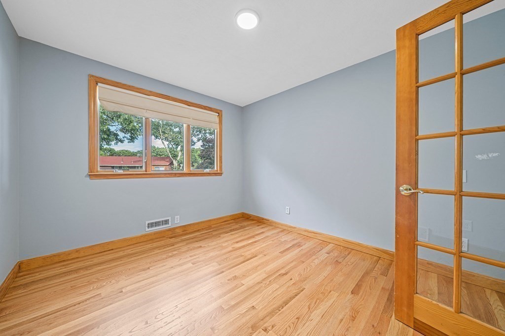 19 Ledge Hill Street Randolph, MA 02368 - Photo 14 of 37 a view of an empty room with wooden floor and a window