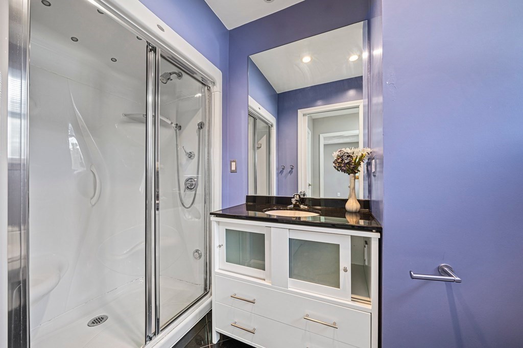 19 Ledge Hill Street Randolph, MA 02368 - Photo 20 of 37 a bathroom with a granite countertop shower a sink and a mirror