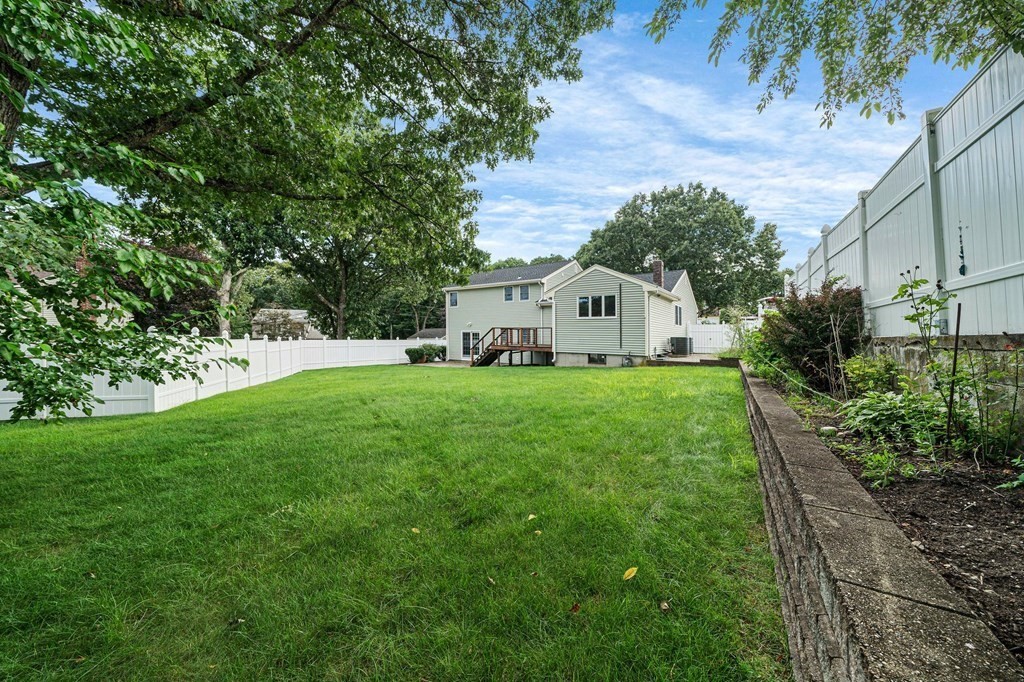 19 Ledge Hill Street Randolph, MA 02368 - Photo 30 of 37 a white house with a big yard and large trees