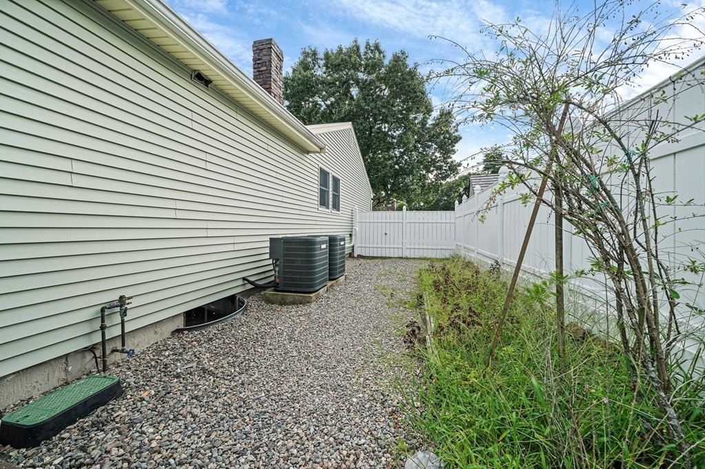 19 Ledge Hill Street Randolph, MA 02368 - Photo 32 of 37 a view of a backyard with plants and a large tree