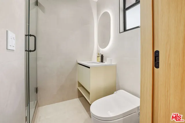 a white toilet sitting next to a bathroom sink