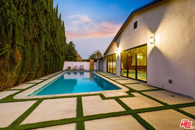 a view of swimming pool with seating area