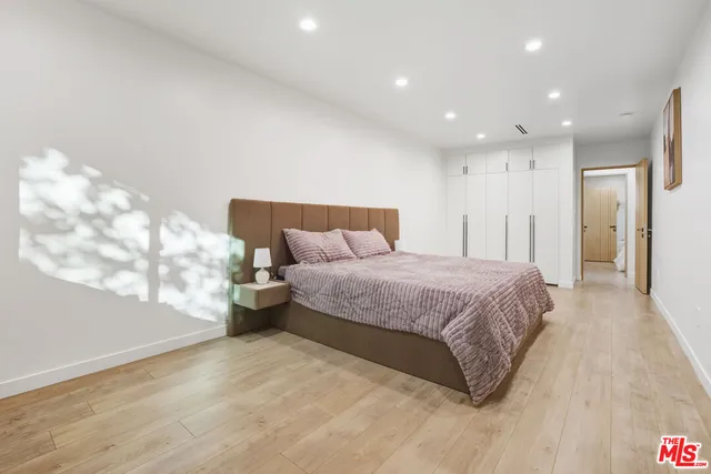 a spacious bedroom with a bed and a window