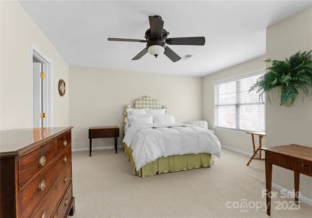 a bedroom with a bed and a desk