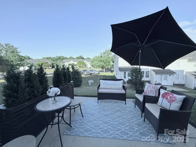a patio with a table and chairs